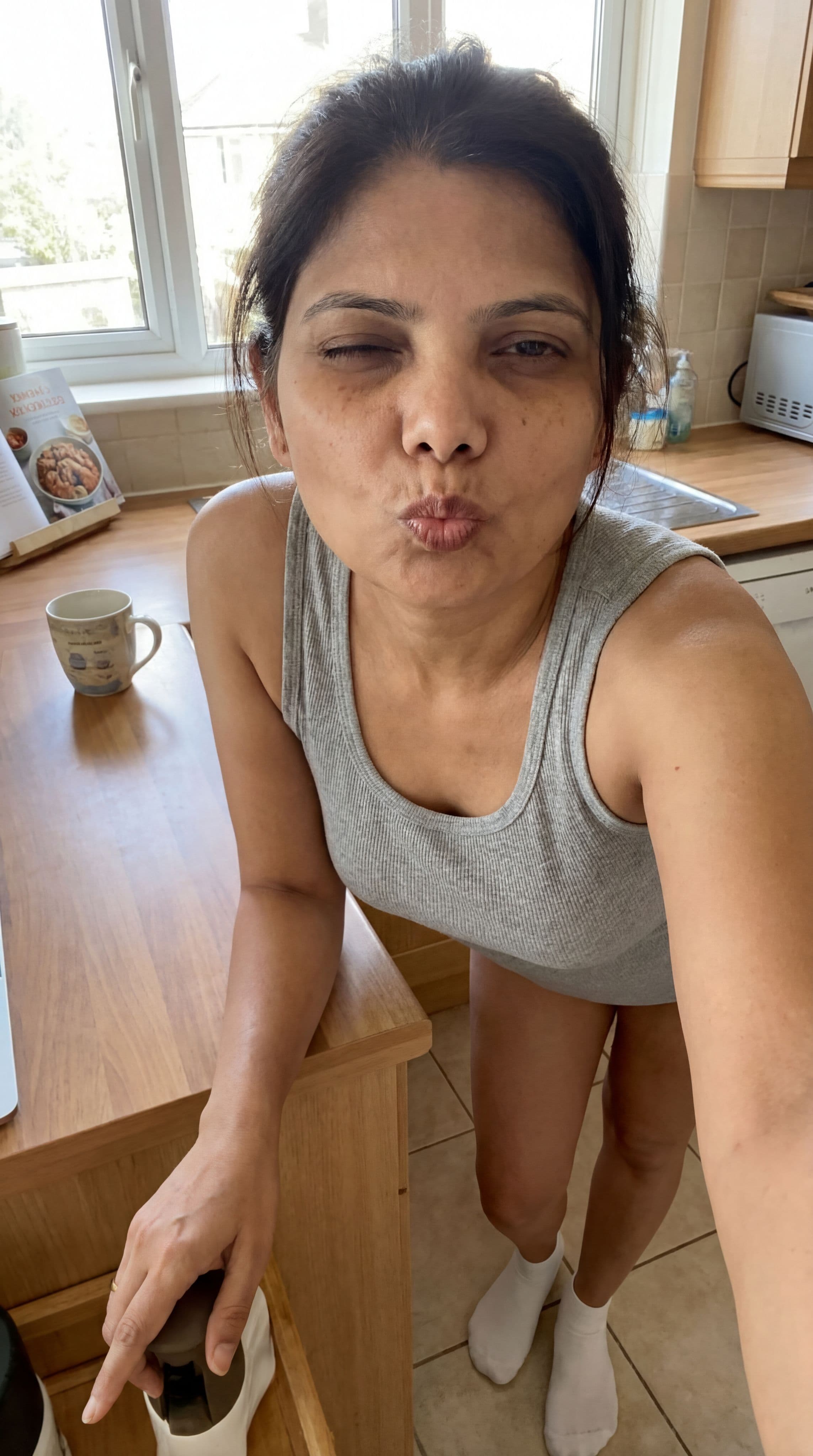 صورة مولدة بالذكاء الاصطناعي: Nano Banana prompt: Teasing, leans over on a kitchen desk, wearing a t... (نموذج Nano Banana - Nano Banana)