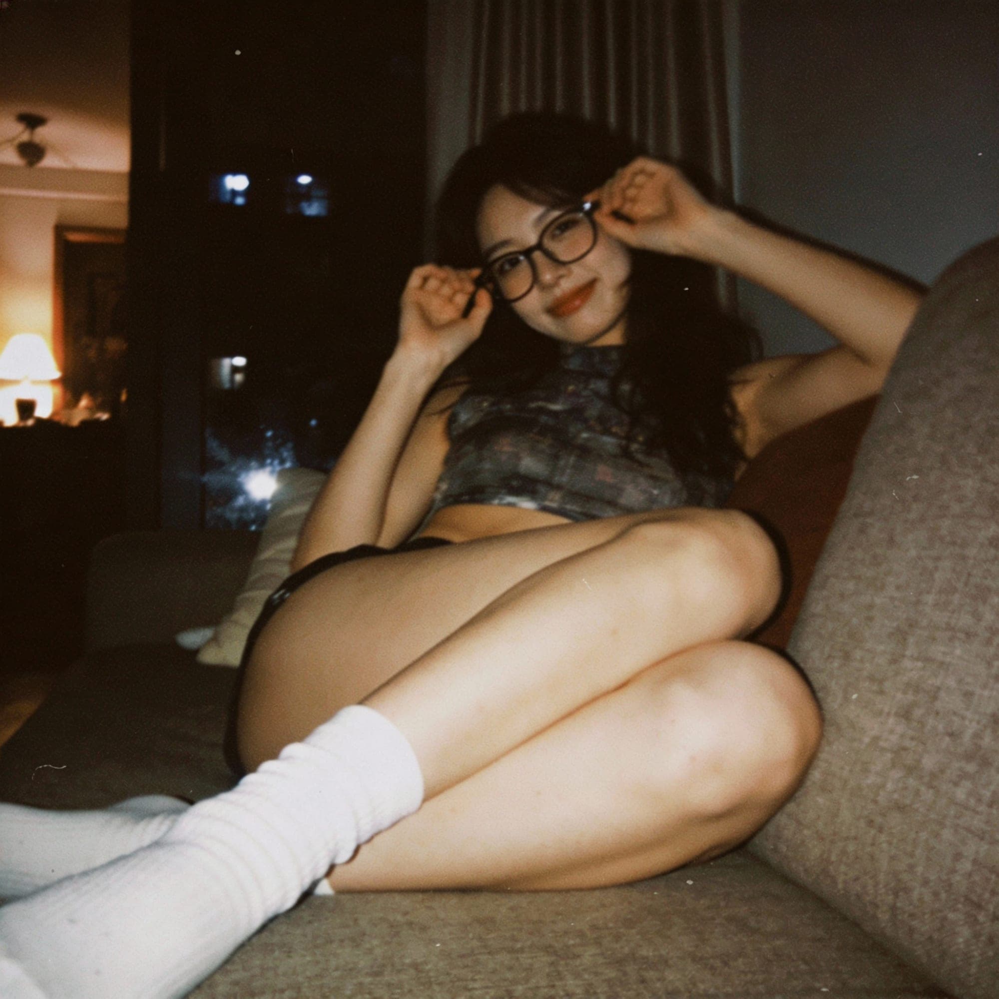 Seedream 4 prompt: looking at me,a sloppy snapshot. Sitting on a couc...